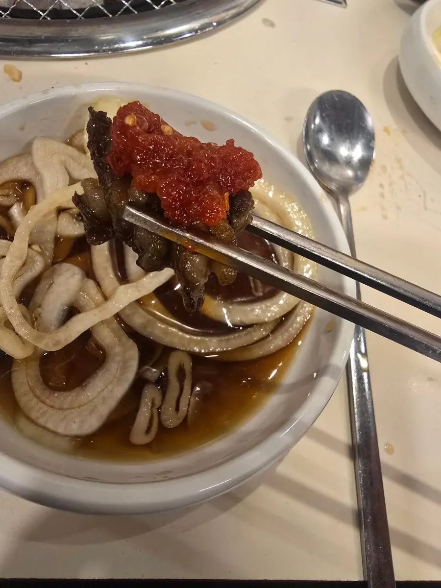 Charcoal-grilled beef galbi dipped in sauce