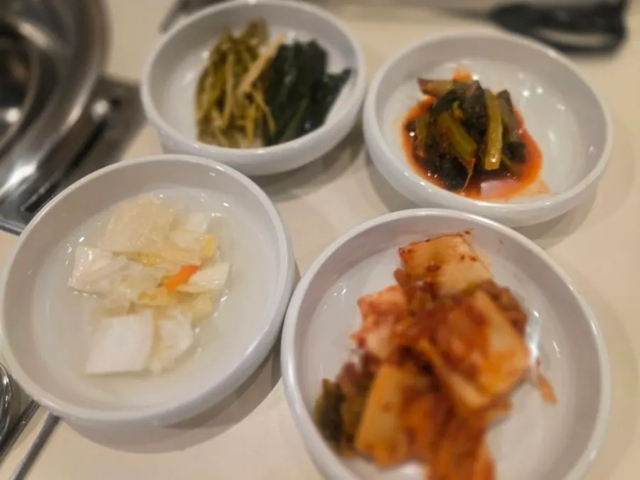 Pickled onion, sauces, and ssam vegetables set out