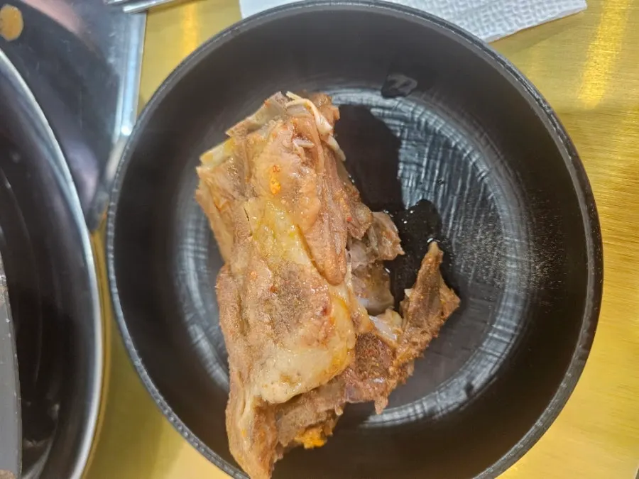 Pot of gamjatang packed with bones