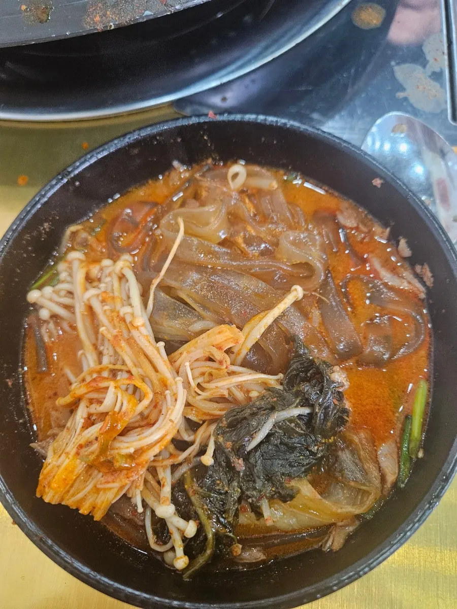 Picking meat off the gamjatang bones with chopsticks