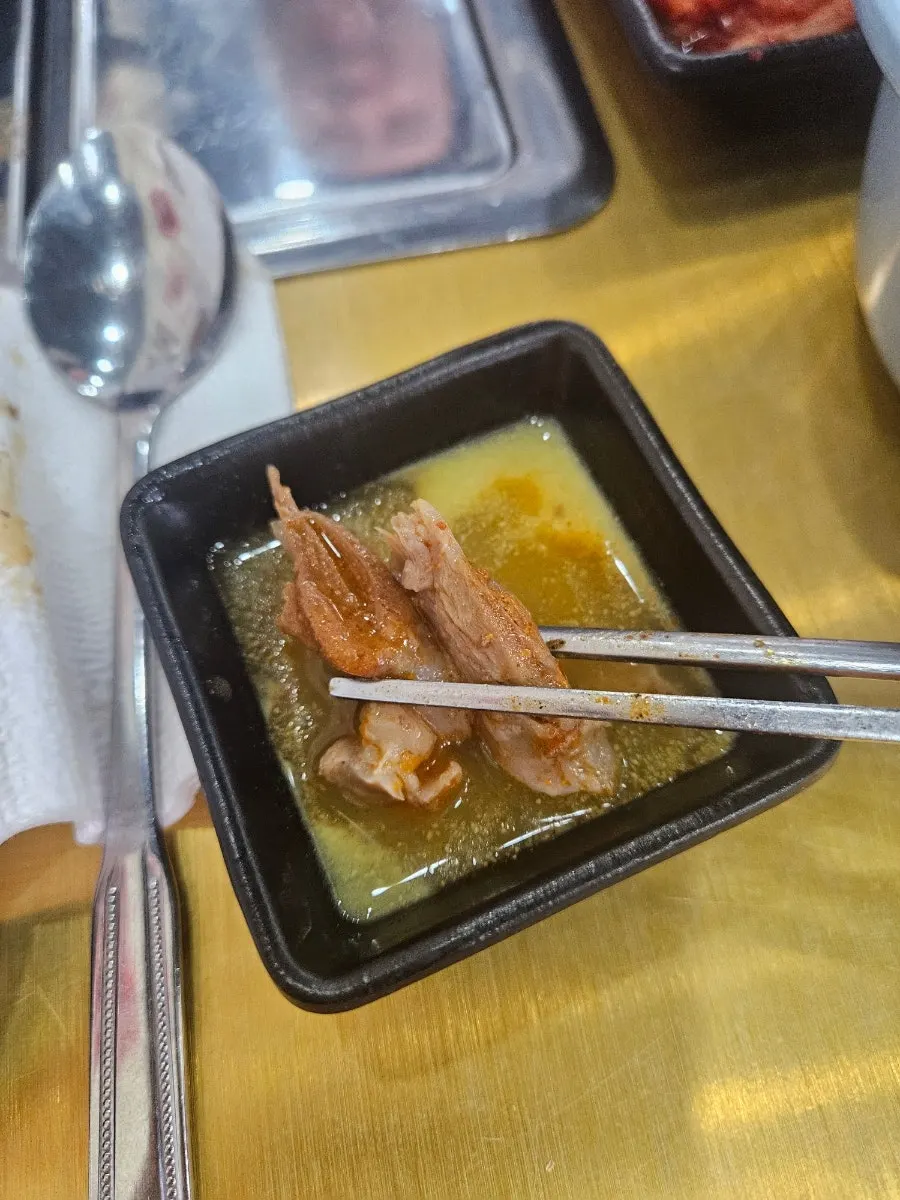 Picked meat and vegetables set aside on a small plate