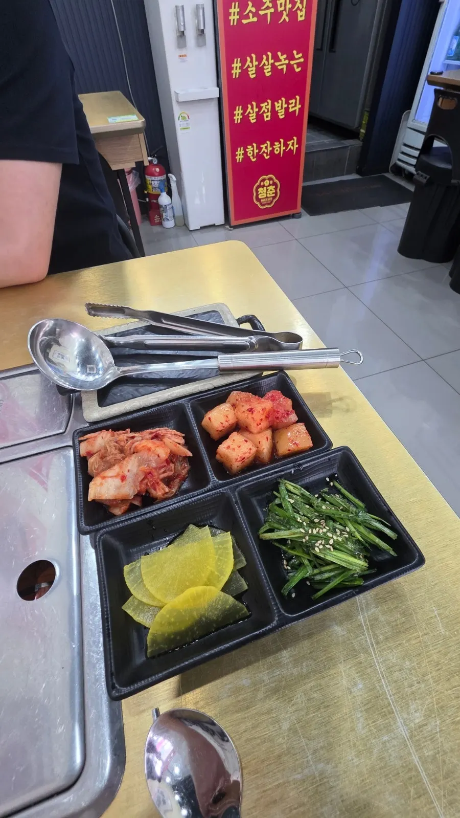 Two kinds of kimchi, seasoned chives and pickled radish as basic side dishes