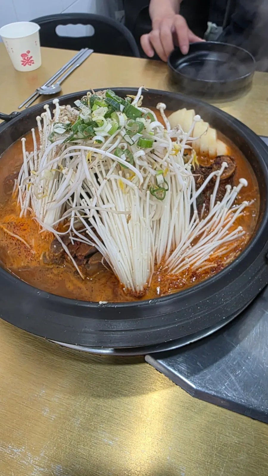 Small-size gamjatang topped with enoki mushrooms and bean sprouts