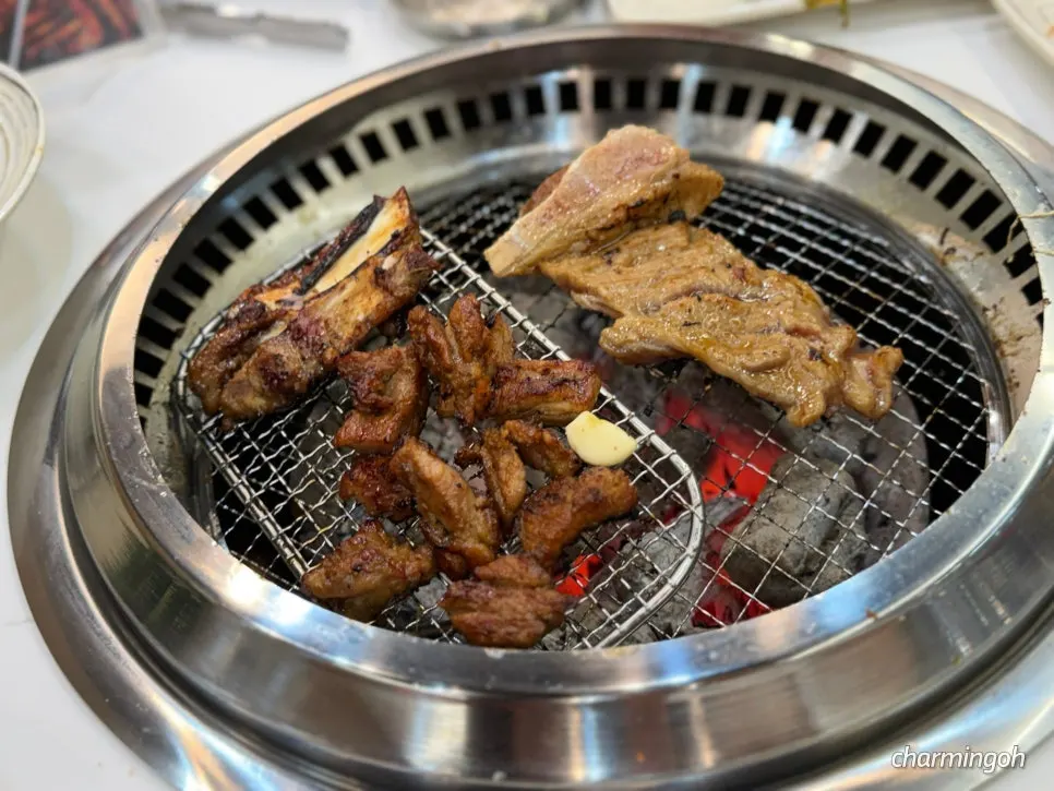 Galbi grilling to a golden brown over charcoal