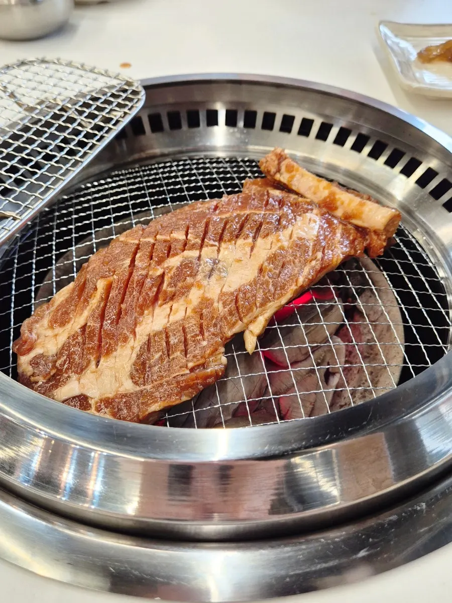 Marinated pork galbi cooking on the charcoal grill