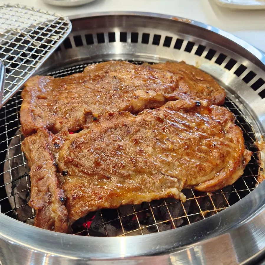 A full spread of charcoal-grilled marinated galbi