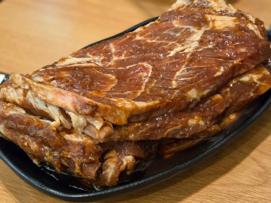 Jeongwon seasoned galbi platter on the charcoal grill