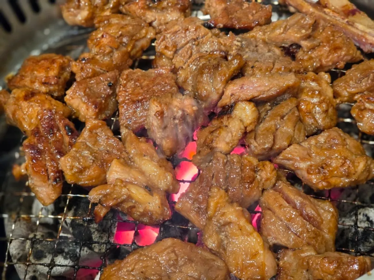 Seasoned pork galbi grilling to a golden brown