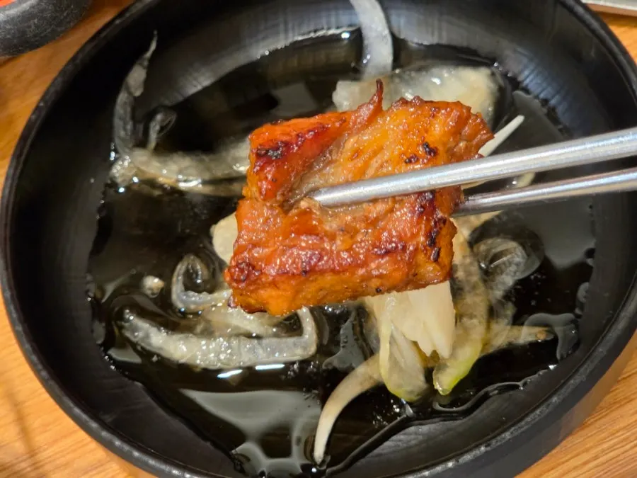 A single piece of sauce-coated pork galbi