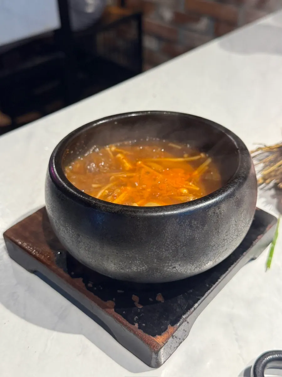 Hanwoo beef doenjang stew served in a black stone pot
