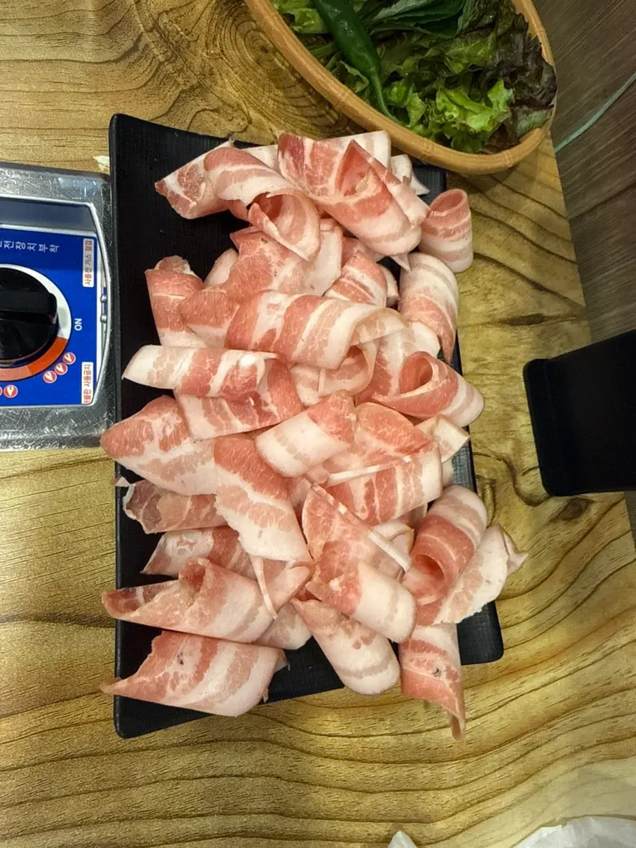 Thin-cut pork belly cooking on the grill