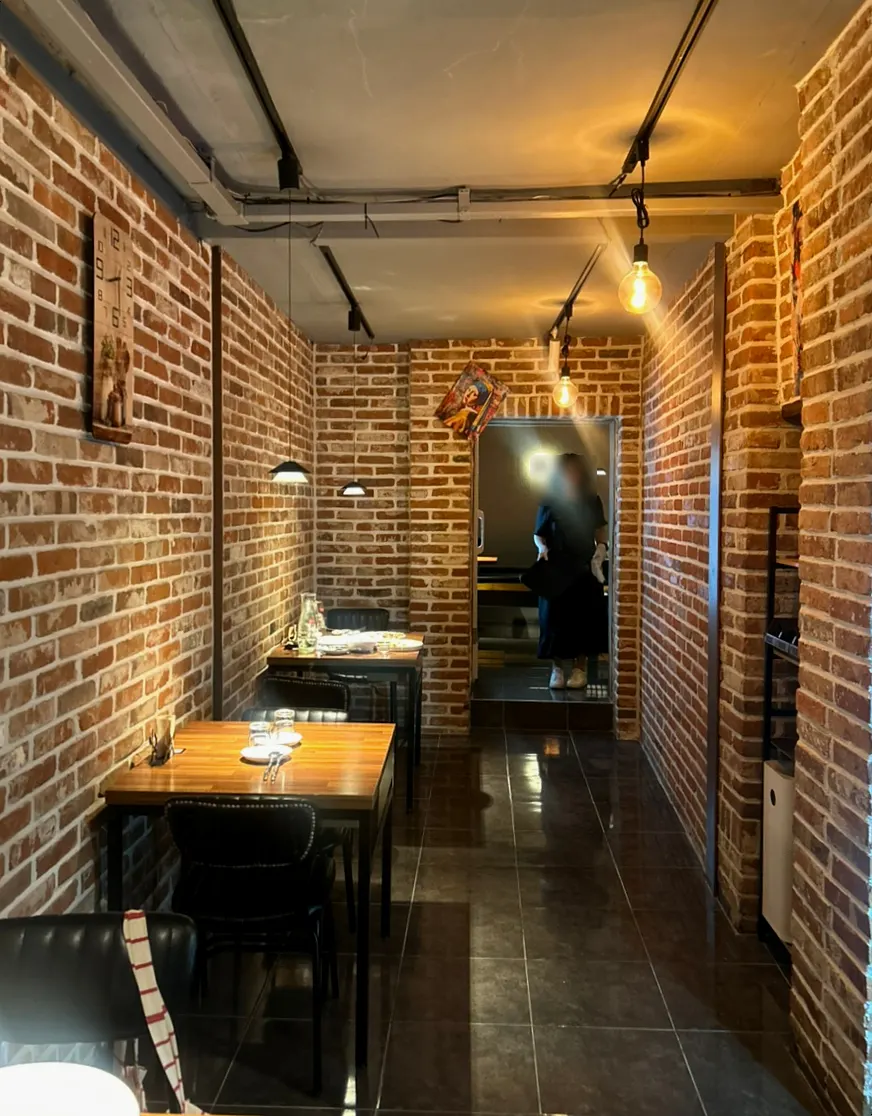 Dark-toned seating inside Adam