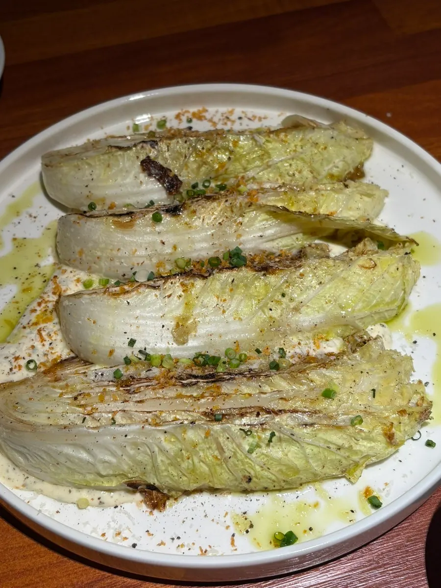 Grilled cabbage topped with sauce
