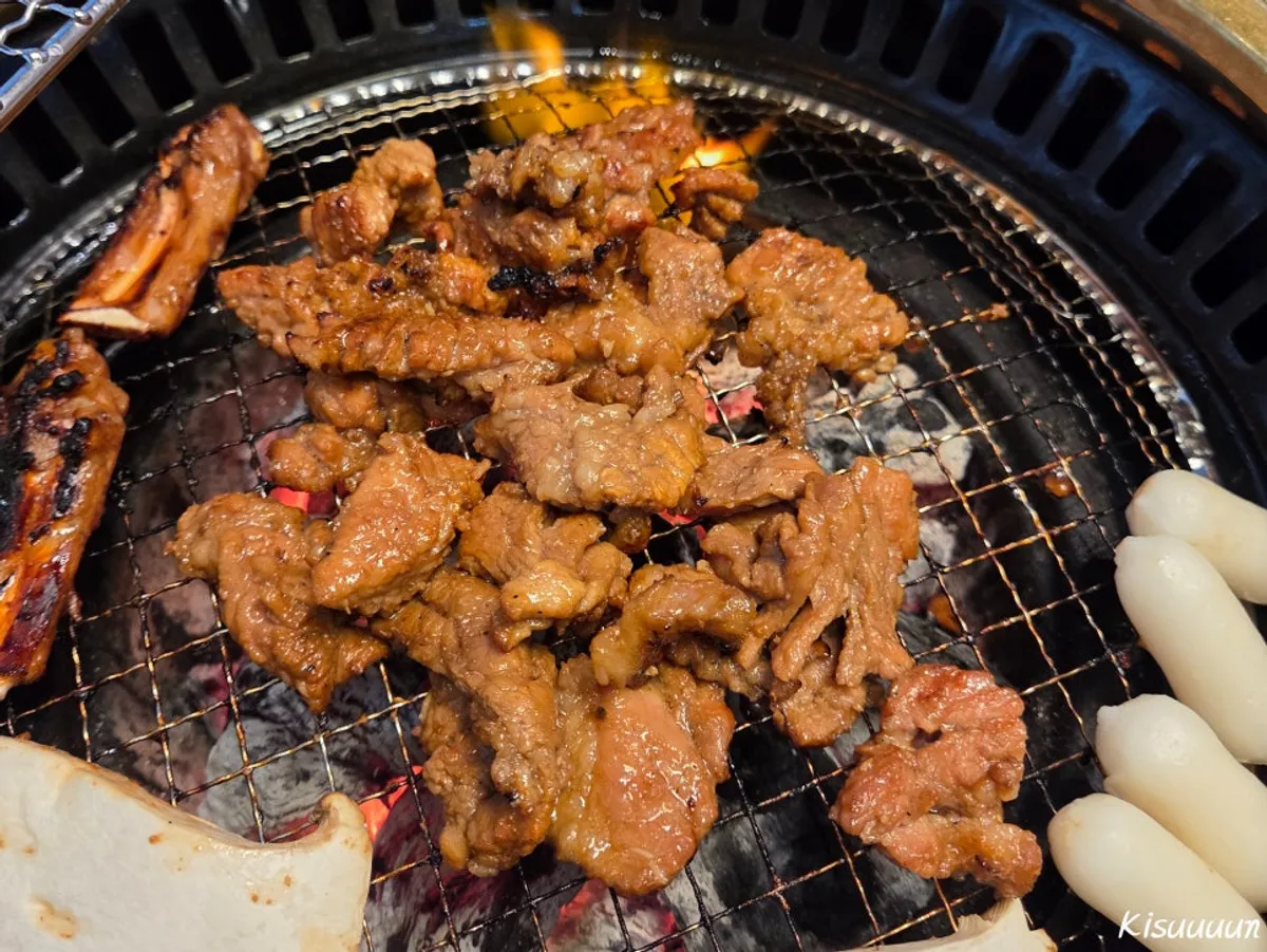Marinated ribs grilling on the charcoal plate