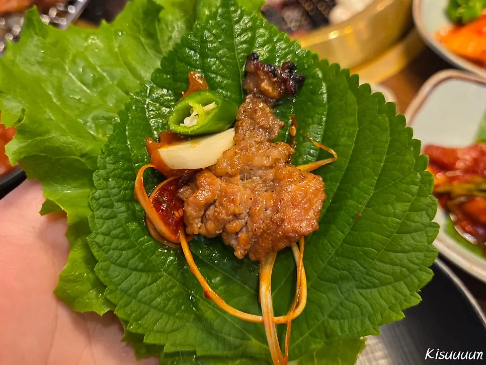 A piece of marinated rib dipped in the special sauce