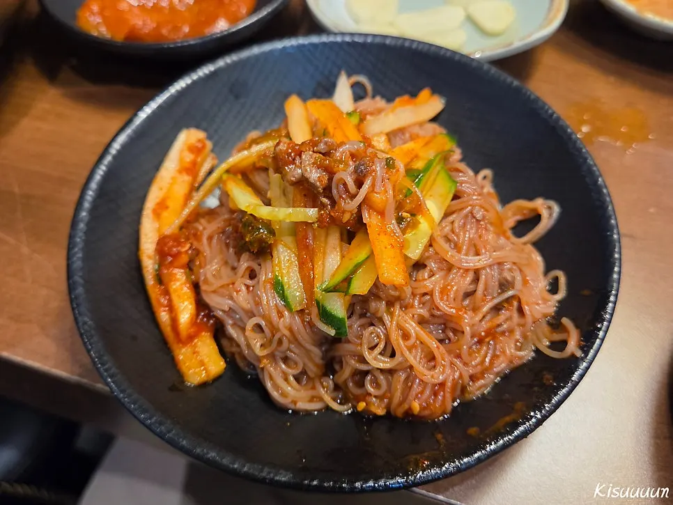 Hamheung-style water naengmyeon topped with a piece of meat
