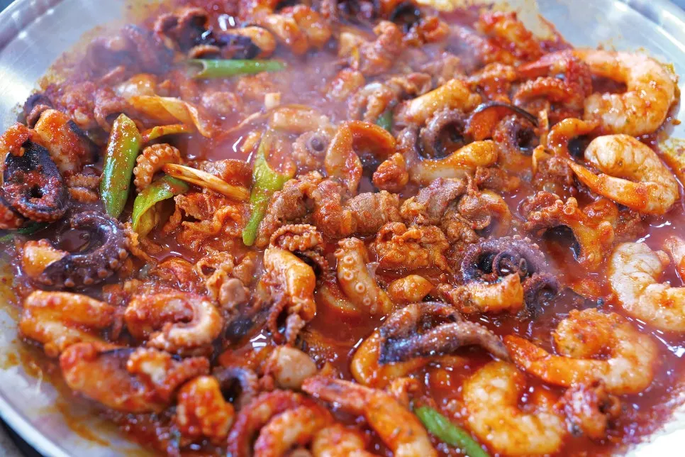 Pulling octopus from the steaming griddle