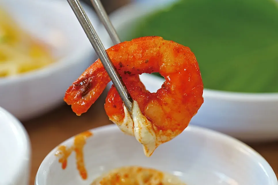 A large shrimp coated in the spicy sauce