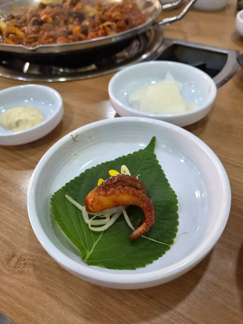 Close-up of jjukkumi coated in sauce