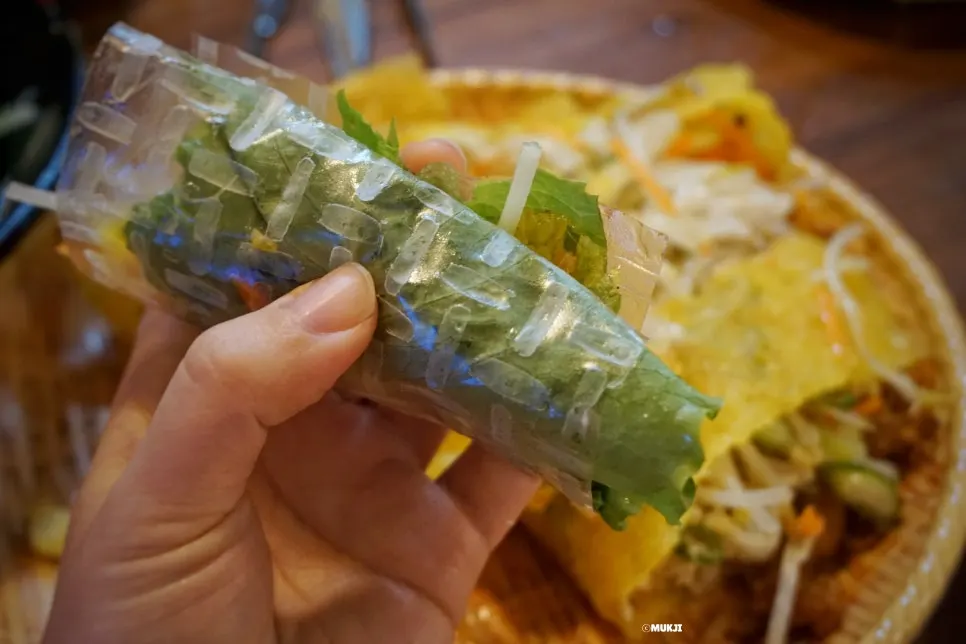Lettuce and banh xeo placed on rice paper