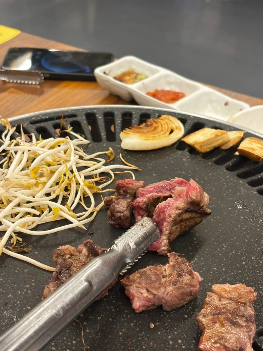 A piece of Korean beef served on bean sprouts
