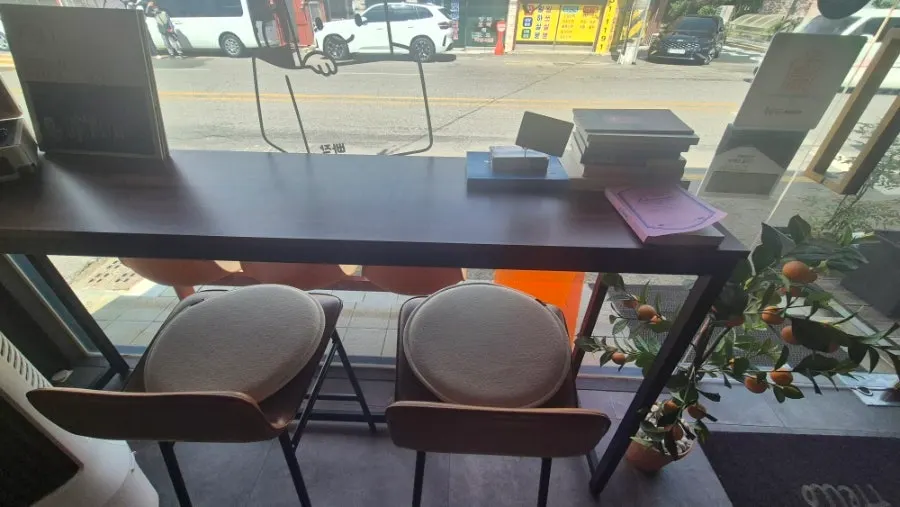 Interior seating area with tables at Ppajak Financier Bar