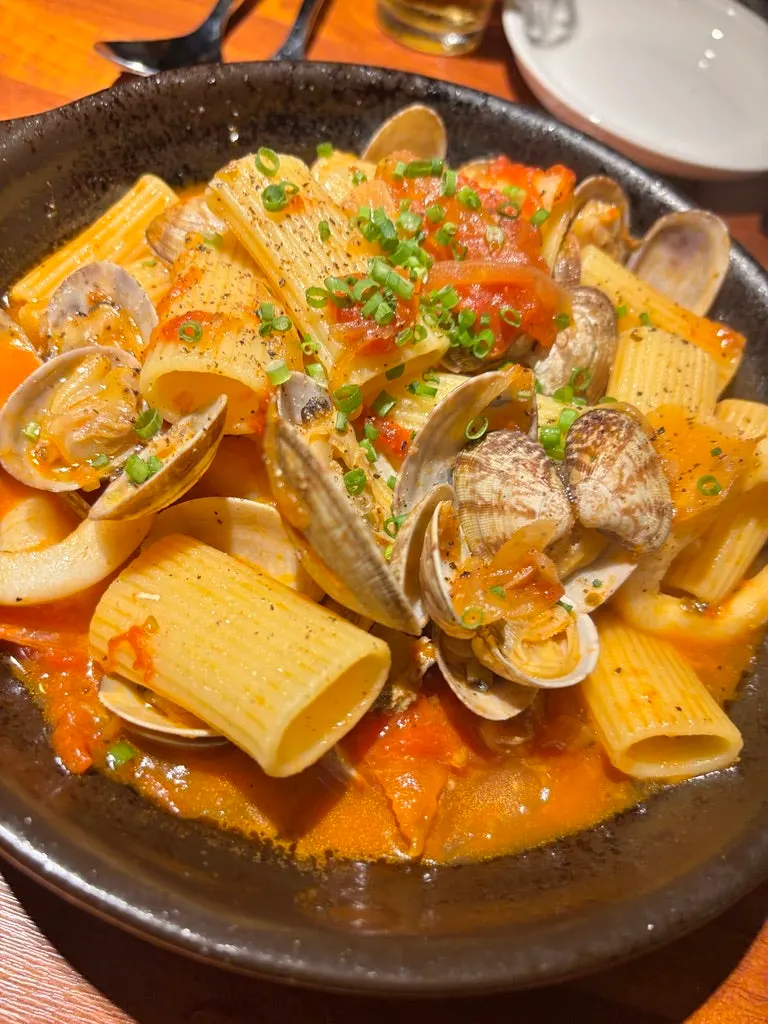 Tomato sauce pasta topped with scallions