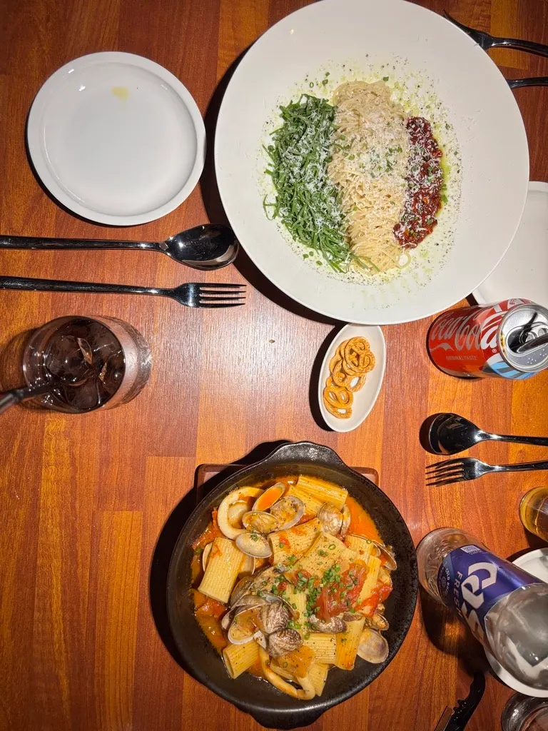 Family sharing a plate of pasta
