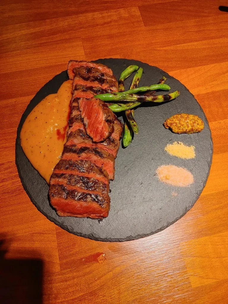 A plate with spicy mashed potato on the side