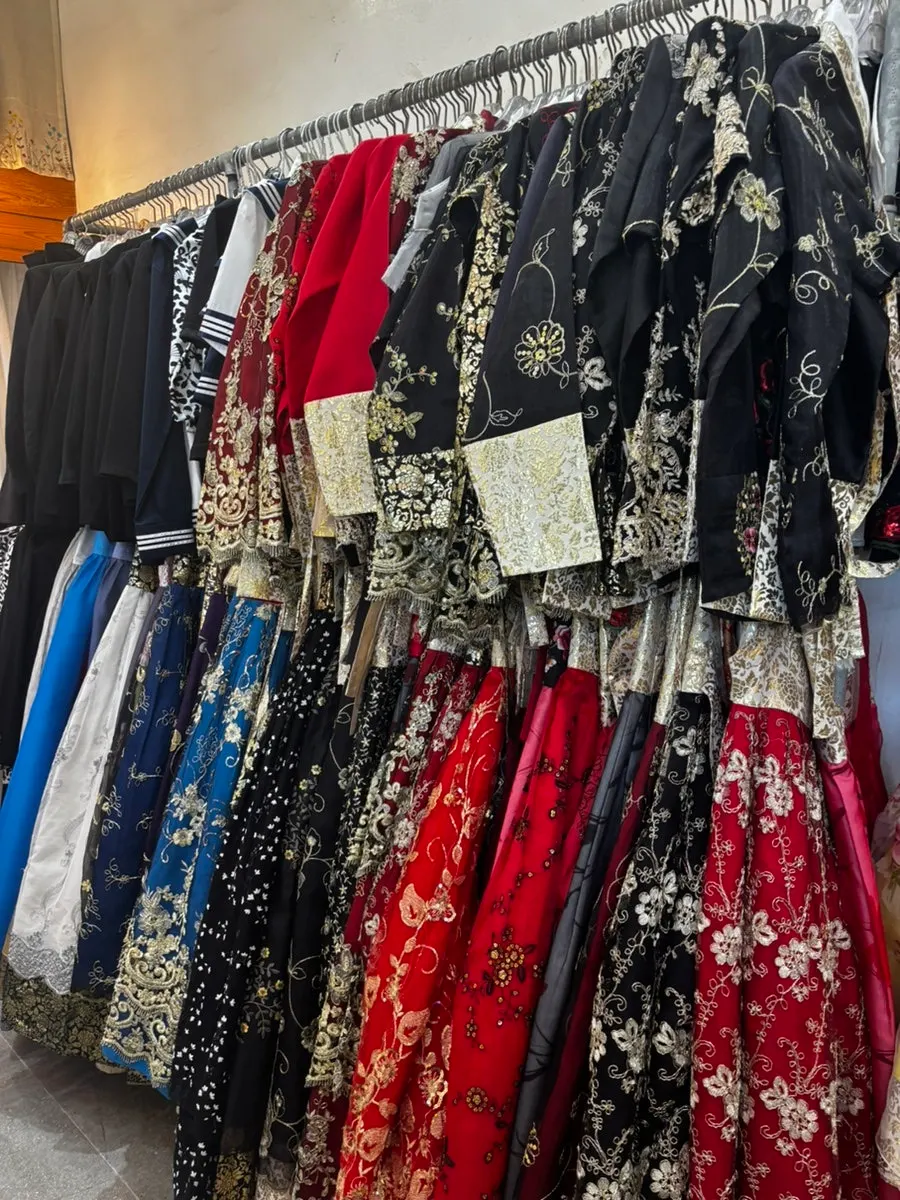 Various hanbok designs on racks at Gwijok Uisangsil