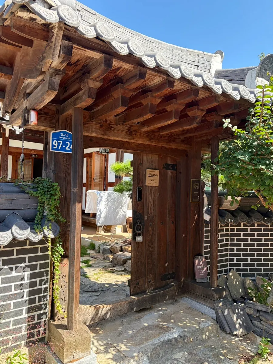 Guesthouse entrance with wooden pillars and a hanok door
