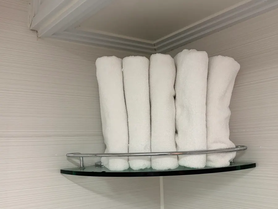 Towels and a hair dryer prepared in the bathroom