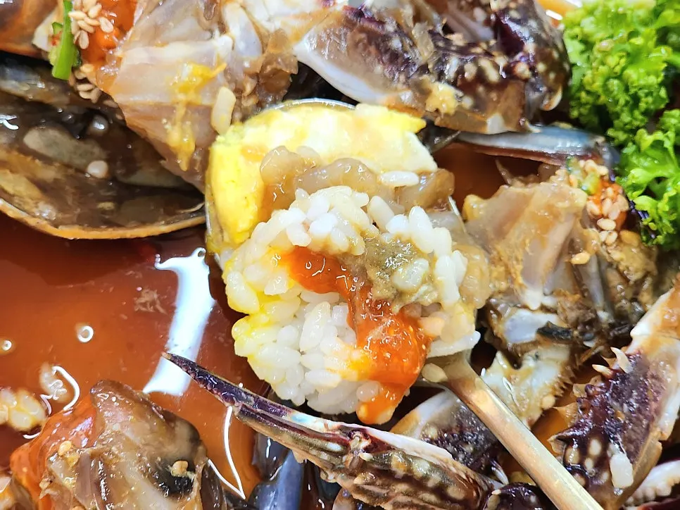 A spoonful of rice topped with crab meat