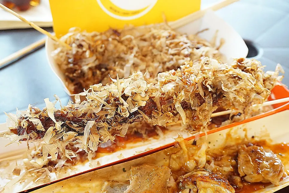 Octopus skewer piled high with bonito flakes