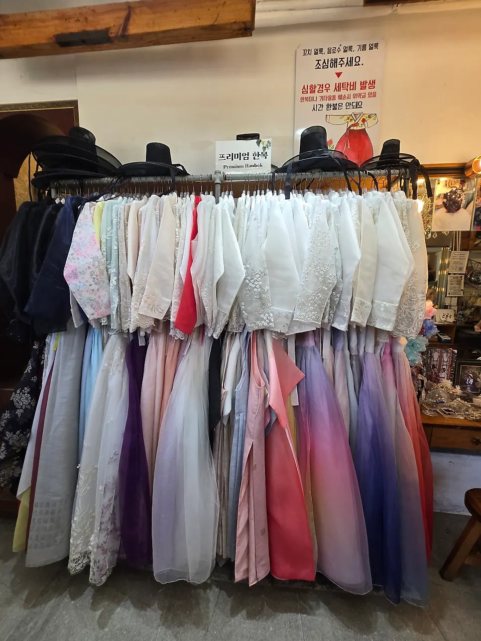 Hanbok skirts and jeogori hung by color inside the shop