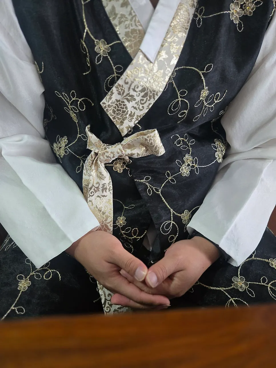 Couple wearing matching durumagi with the same gold-foil pattern