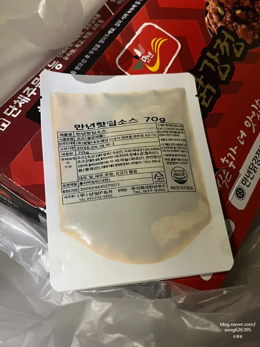 닭강정 포장 박스와 함께 든 만년핫딥소스