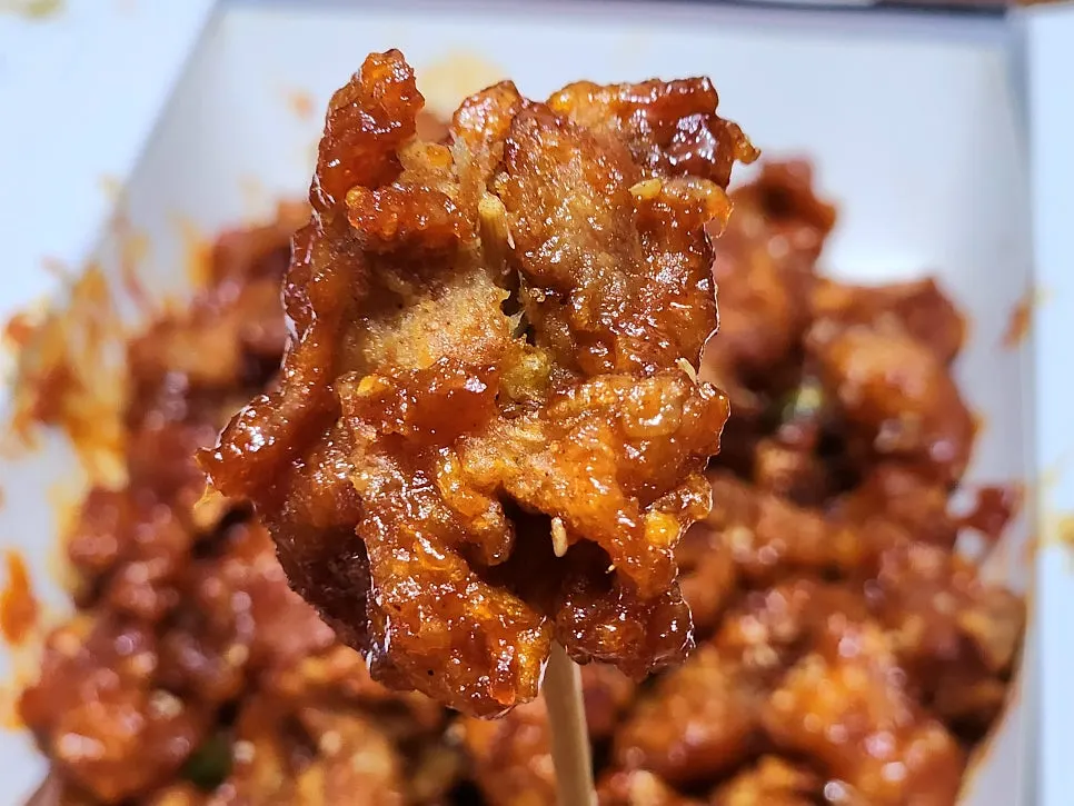 Spicy dakgangjeong topped with cheongyang chili and garlic