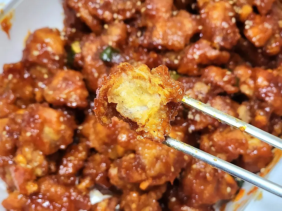 Picking up a chunky piece of dakgangjeong