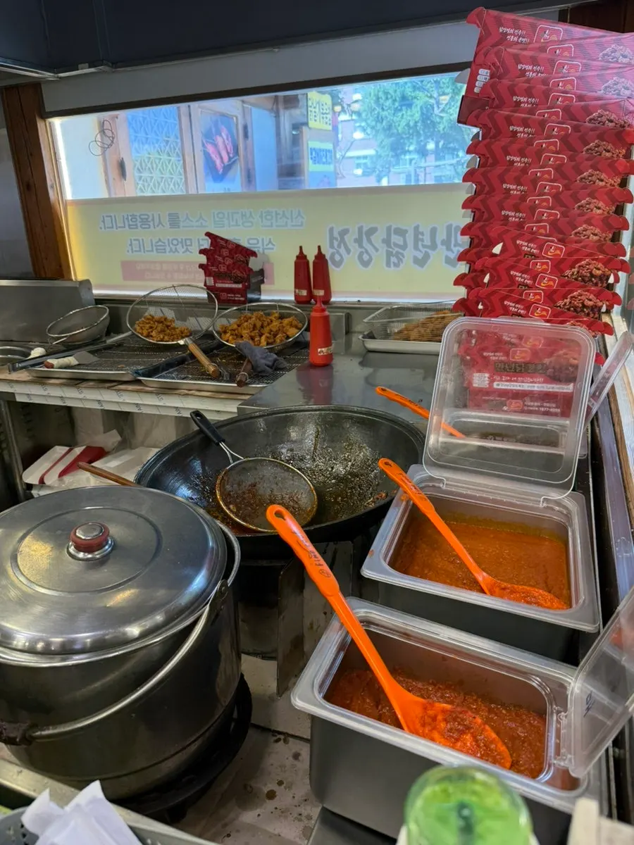 Cooking area where dakgangjeong is fried and tossed in sauce