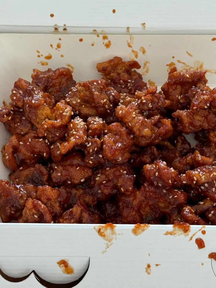 Close-up of sauce-coated boneless chicken thigh dakgangjeong