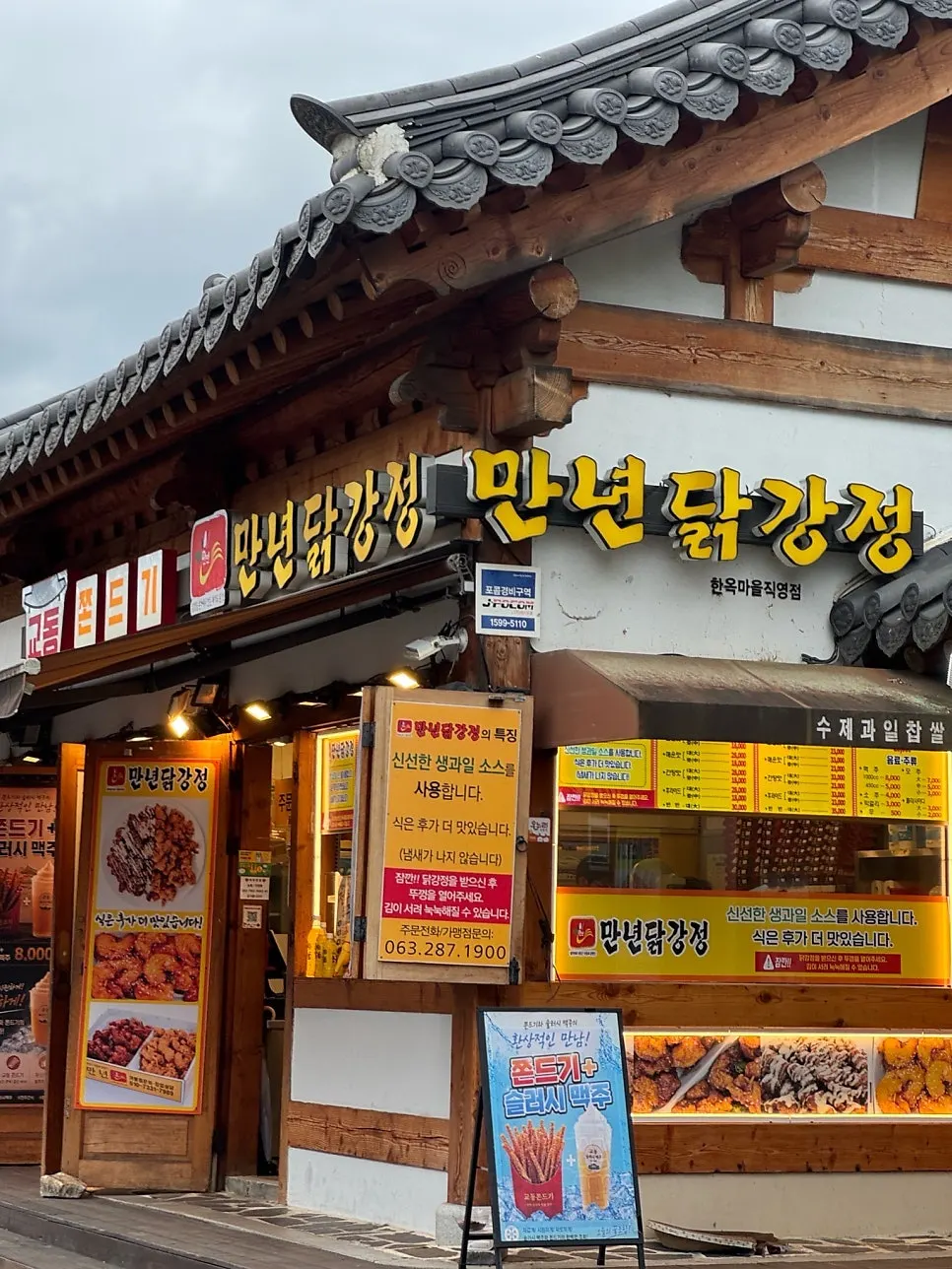 Hanok building exterior and yellow sign of Mannyeon Dakgangjeong in Jeonju Hanok Village