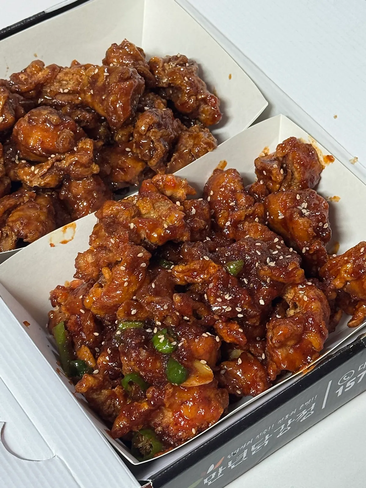 Opened box showing soy and spicy dakgangjeong half-and-half