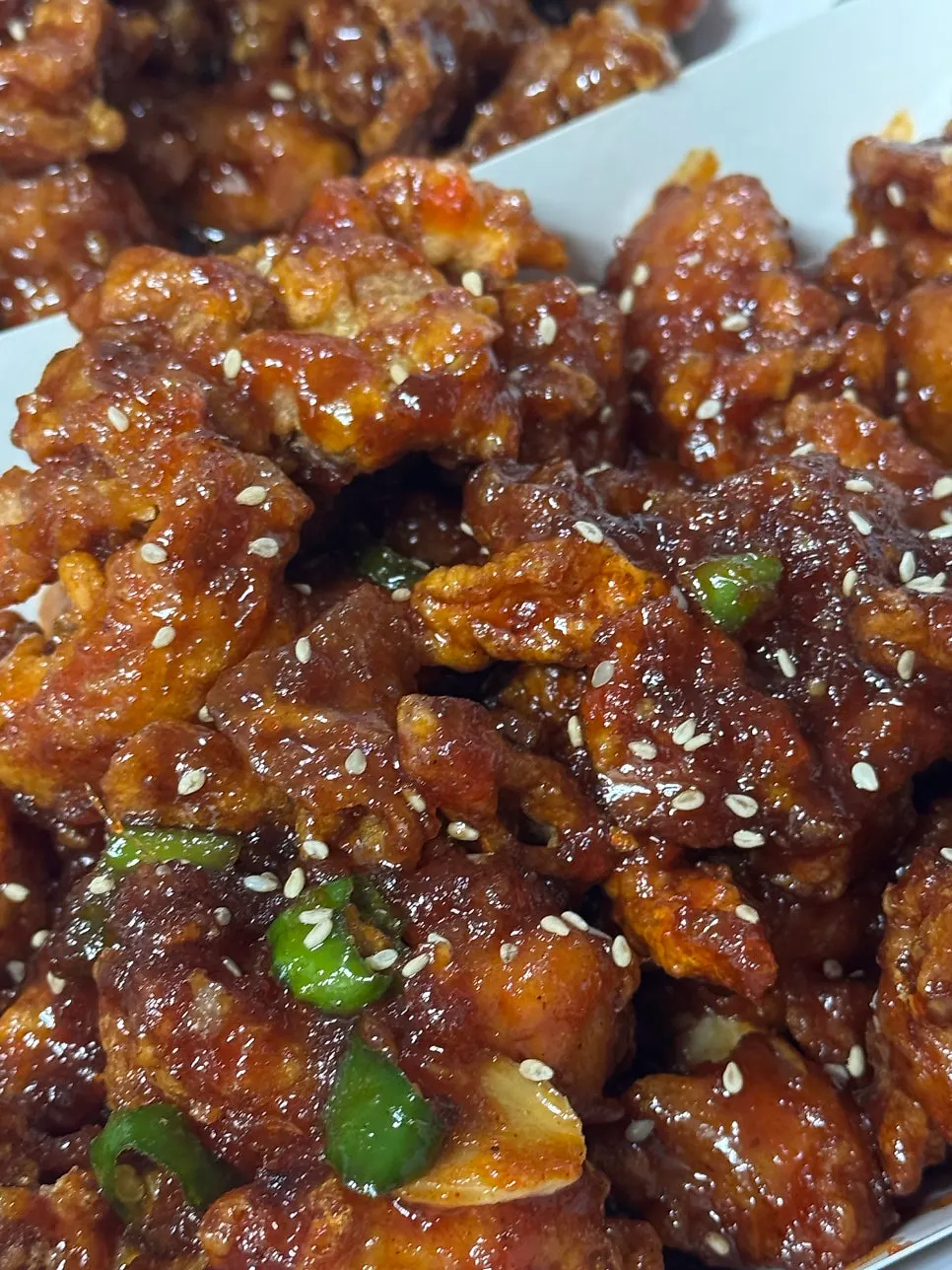 Spicy dakgangjeong topped with cheongyang chili and garlic