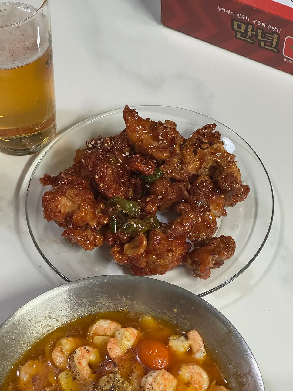 Spicy dakgangjeong set up as a beer snack spread
