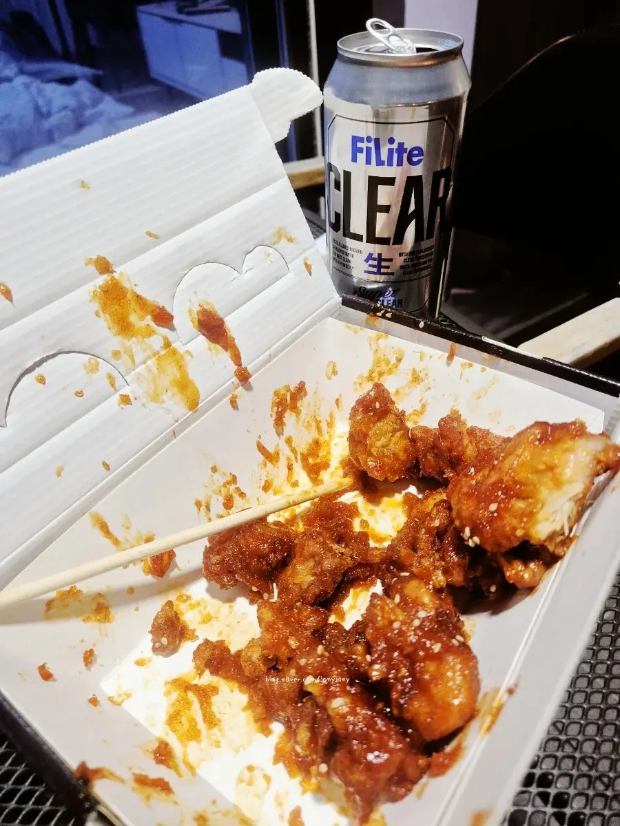 Nearly empty dakgangjeong takeout box