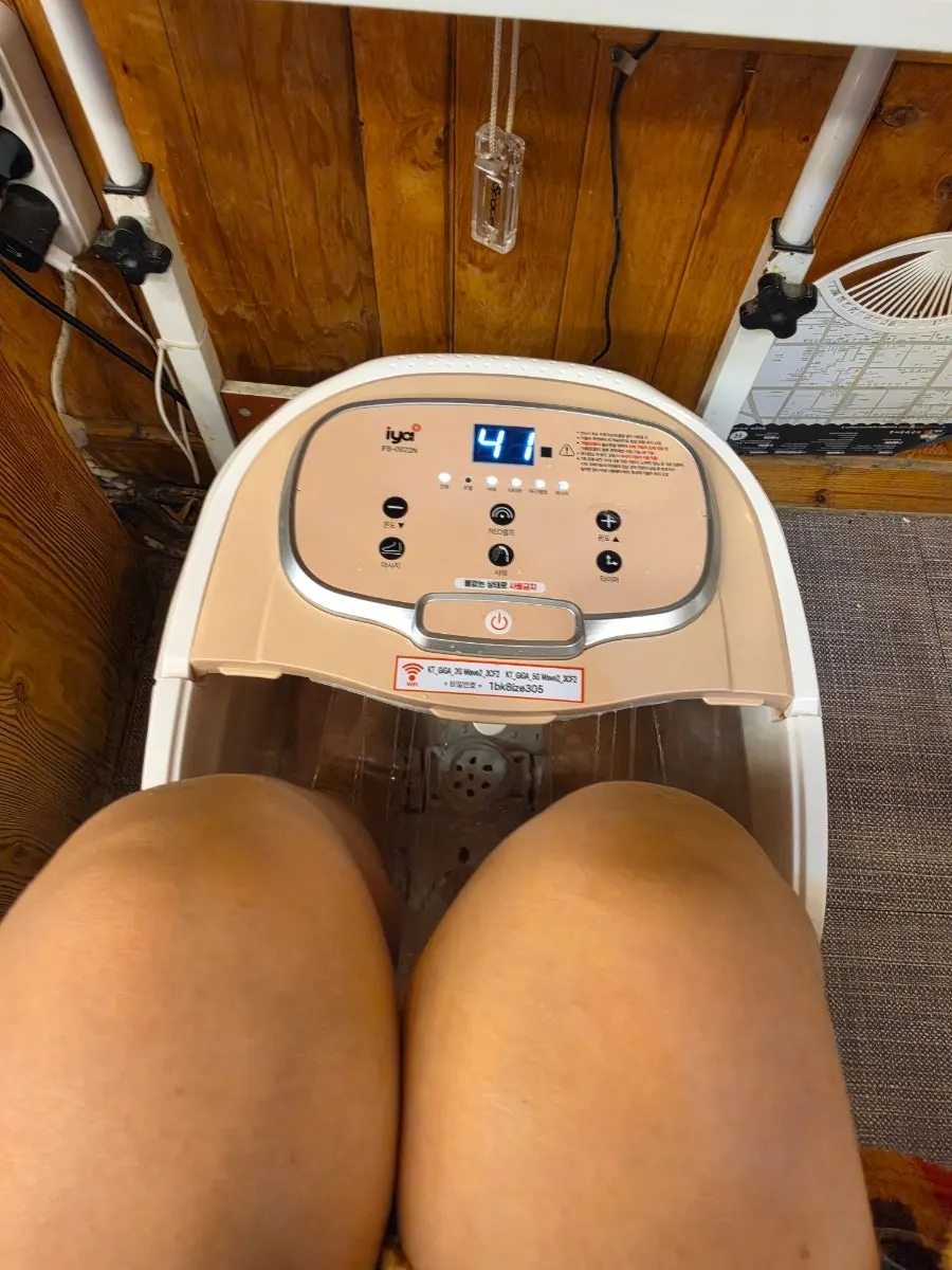 Relieving hand fatigue with a hand massage device while foot soaking