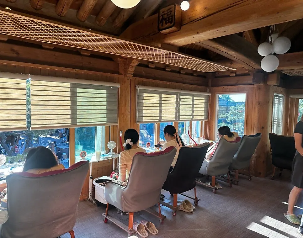 Window seats lined up in front of the full-length glass at the foot bath café
