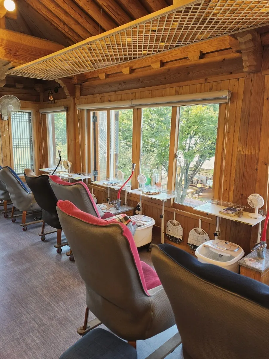 Interior of the café with a foot bath machine at every seat