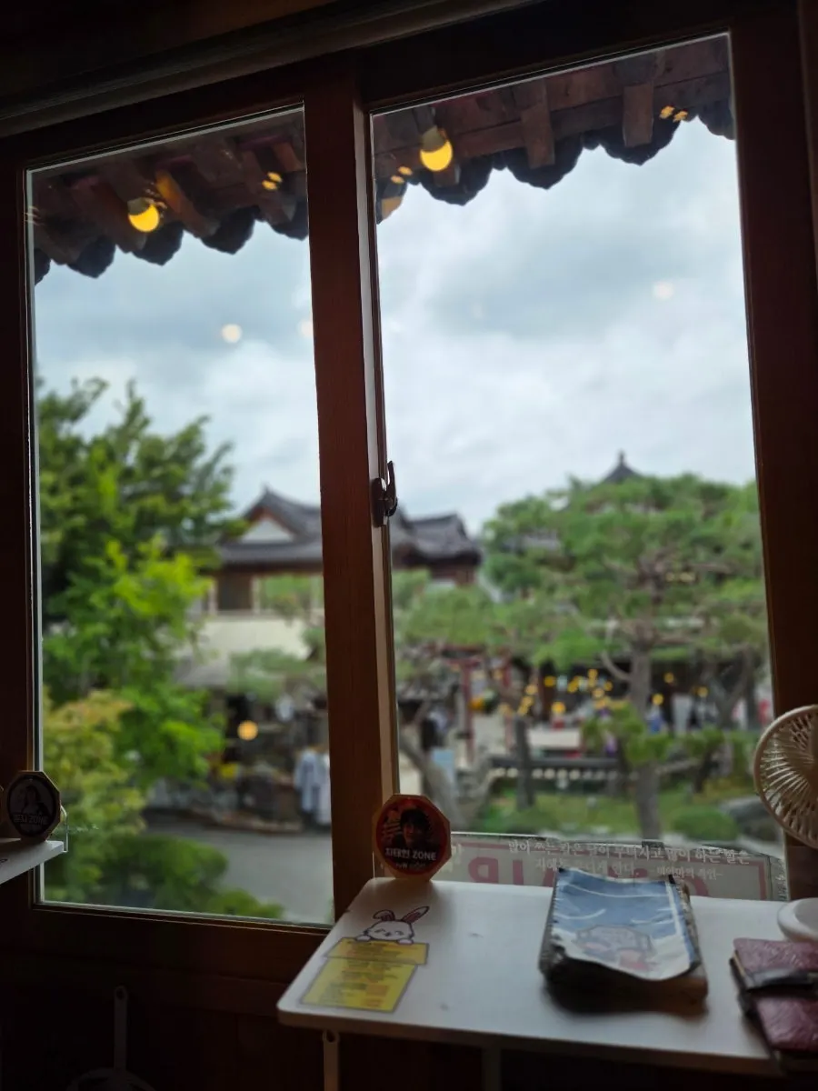 View of hanok tiled roofs seen through the window